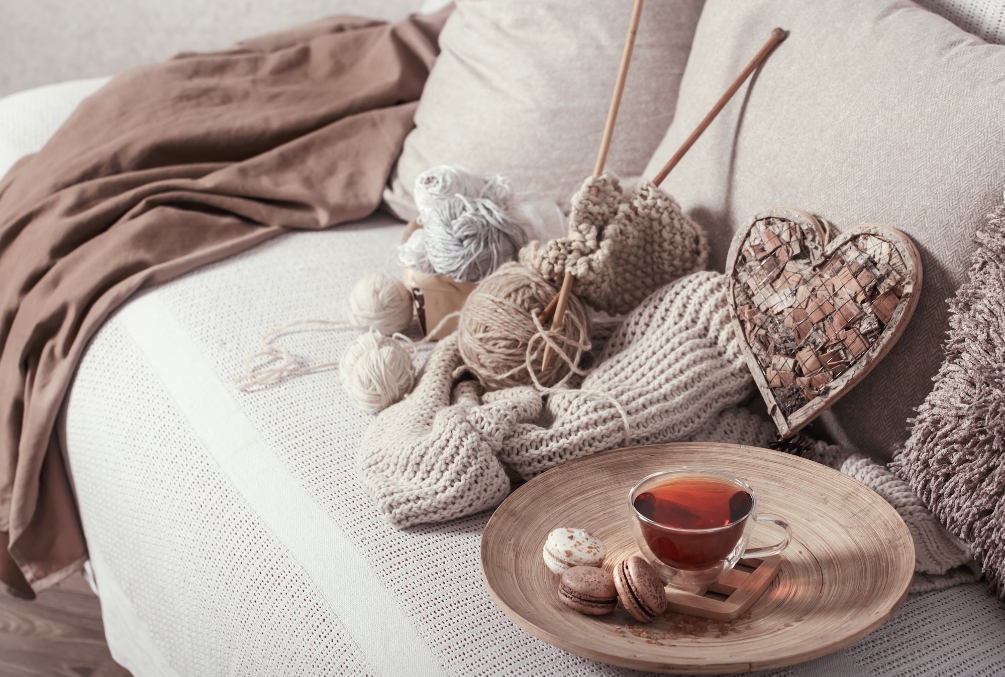 vintage knitting needles and yarn with a cup of tea