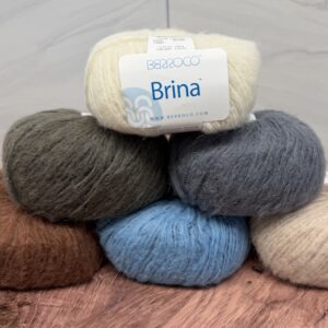 Berroco Brina, worsted-weight yarn in ivory, dark olive brown, charcoal blue-gray, rust, denim blue and warm beige with delicate mini sequins.