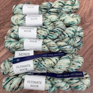 Malabrigo Ultimate Sock Minis 230 Sea Horse, pale cream with turquoise, teal and brown speckles mini skeins of fingering-weight yarn.