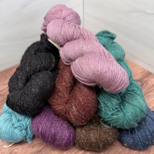 Urth Yarns Trill Assorted Colors fingering weight yarn skeins in heathered colors.